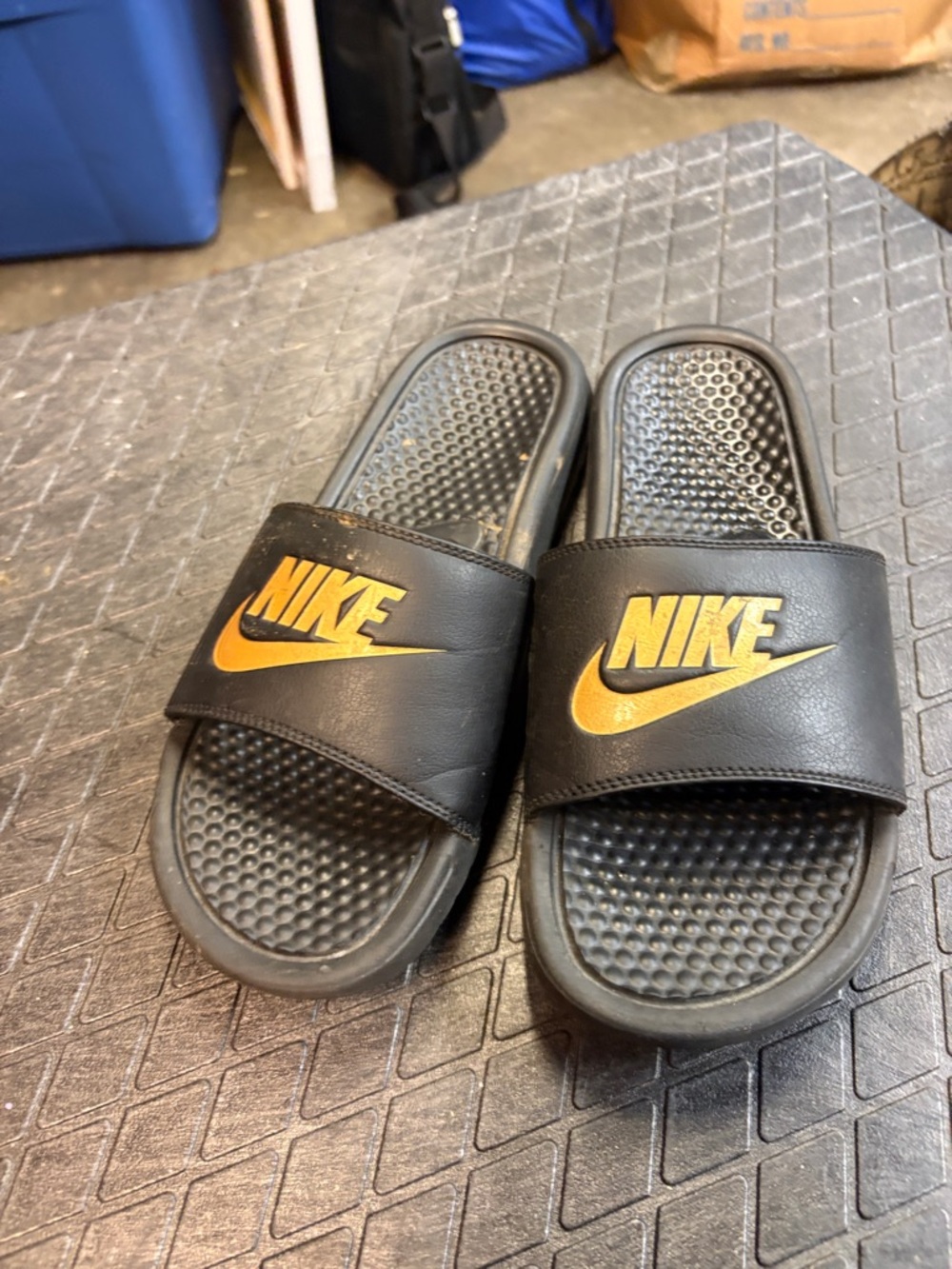 Nike Black Slides with Gold Swoosh Logo